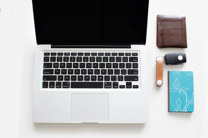 Laptop,Wallet,Keys An Blue Book On White Desk Photo