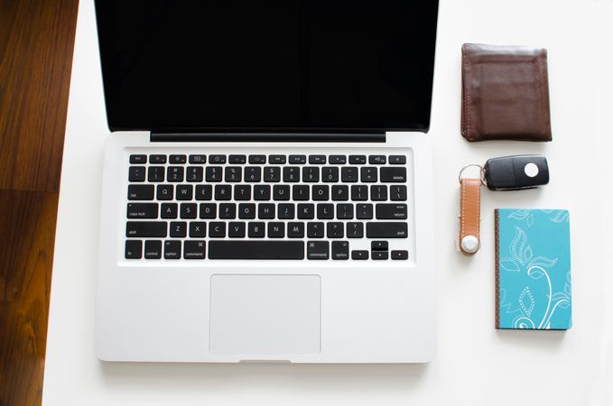 Laptop,Wallet,Keys An Blue Book On White Desk Photo