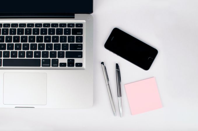 Macbook,Iphone ,Pens And Pink Sticky Note On White Table Photo