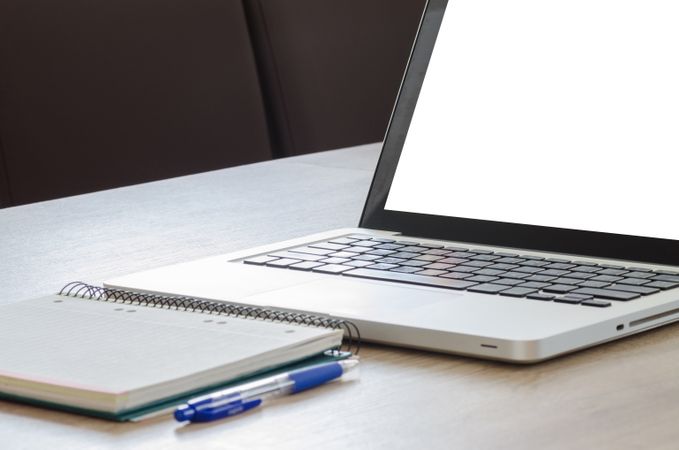 Macbook On Table Beside Spiral Notebook Photo
