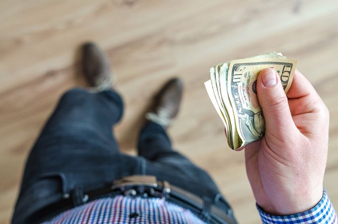 Man Holds 10 U.s Dollar Banknote Photo