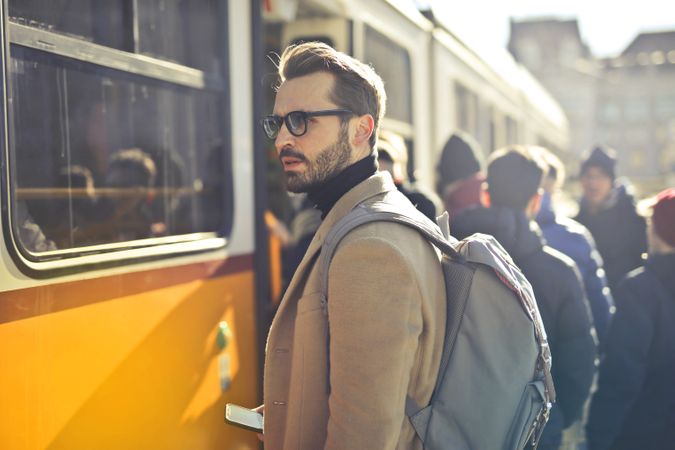 Man In Brown Coat And Gray Backpack Posing For A Photo Photo