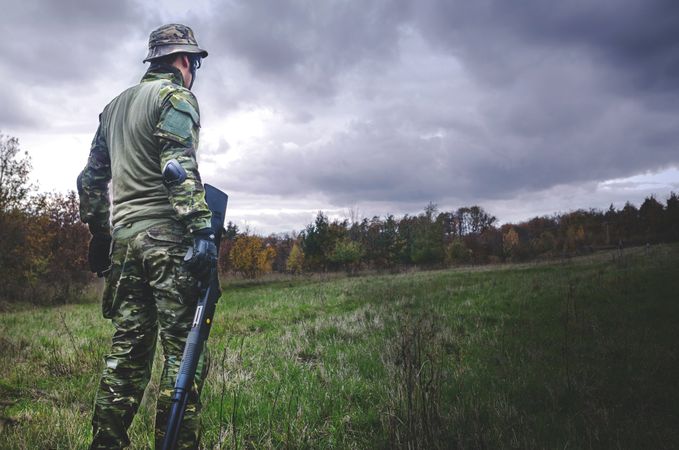 Man In Camouflage Soldier Suit While Holding Black Hunting Rifle Photo