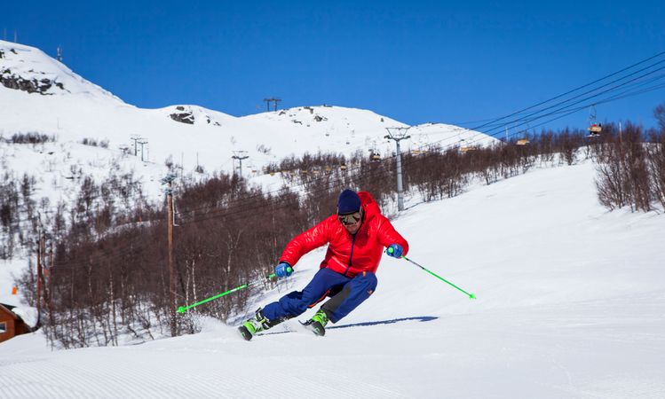 Man Performing Stunt During Snow Surfing On Snow Covered Mountain Photo