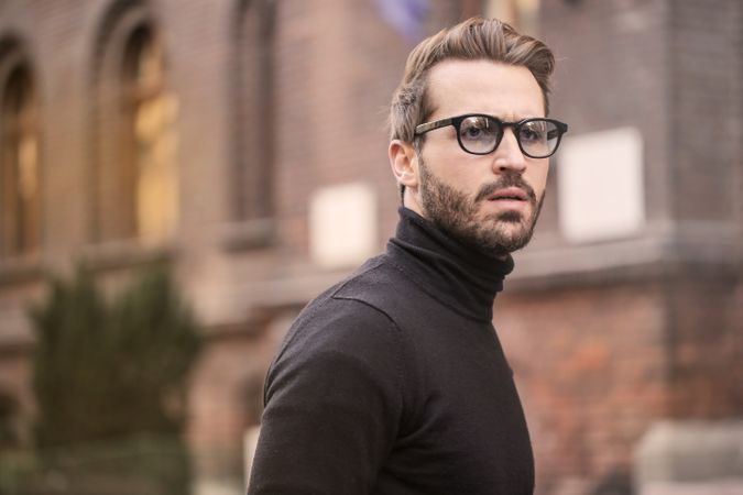 Man Standing Near Building White Black Turtleneck Shirt Photo
