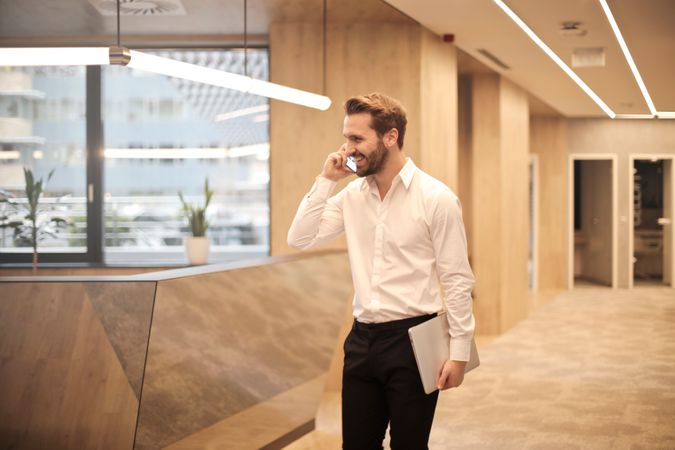 Man Talking On Mobile At Office Photo