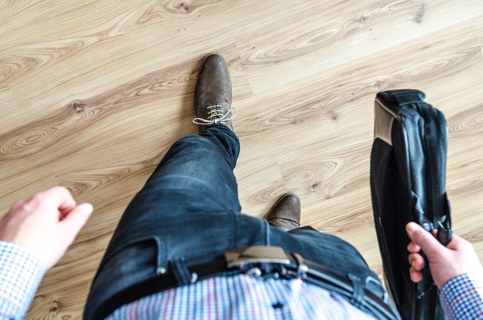 Man Walking And Holding Leather Bag Photo