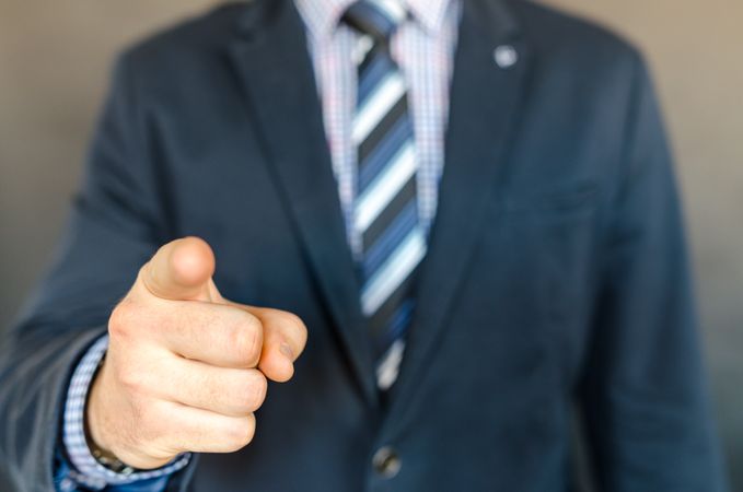 Man Wearing A Suit Jacket And Stripe Necktie And Point Out Gesture Photo