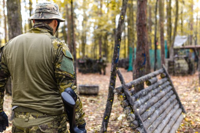 Man Wearing Camouflage Suit While Holding A Gun Photo