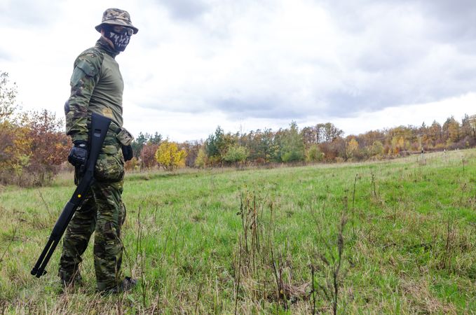 Man Wearing Green Combat Uniform Holding Rifle Photo