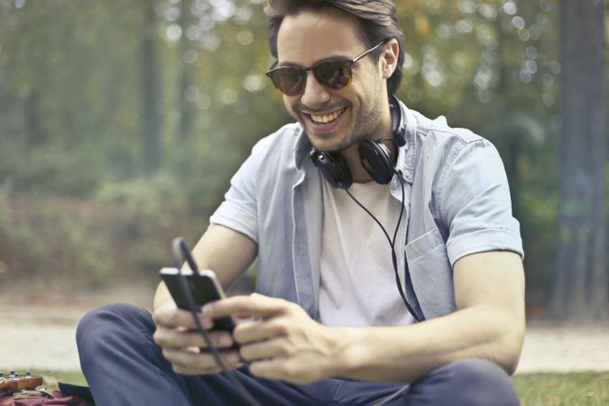 Man Wearing Sunglasses Using Smartphone At Daytime Photo