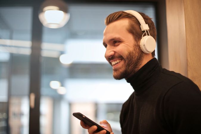 Man Wearing White Headphones Listening To Music Photo