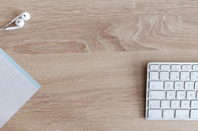 Office Desk With White Keyboard,Earphones And Notebook Photo