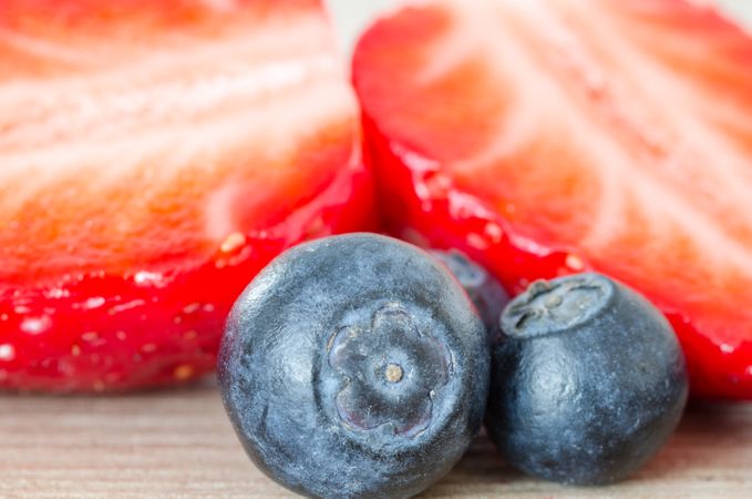 One Half Cut Strawberry And Blueberries On Table Photo