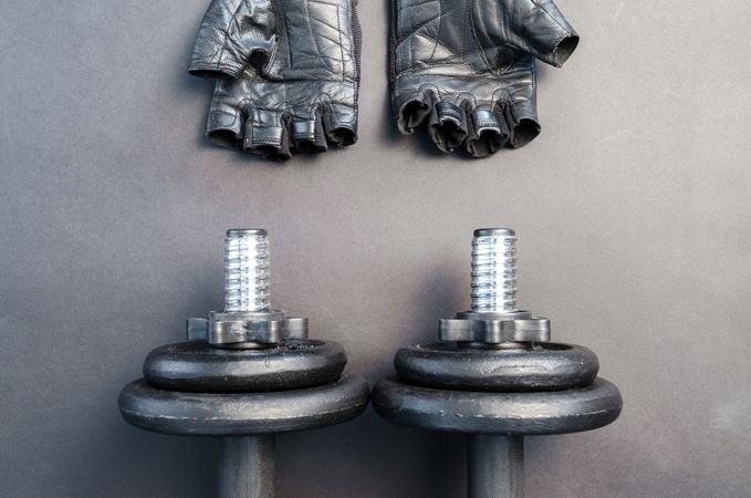 Pair Of Finger Less Gloves And Adjustable Dumbbells Photo
