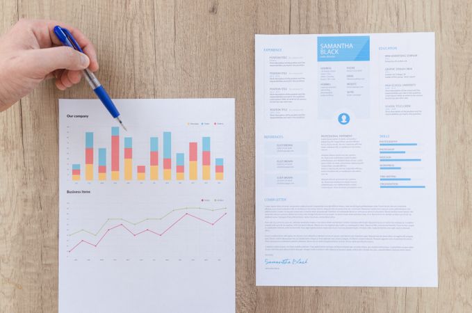 Papers Analysed By Man On Wooden Table Photo