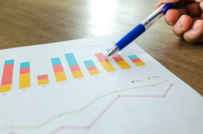 Papers Analysed By Man With Help Of Blue Pen Photo