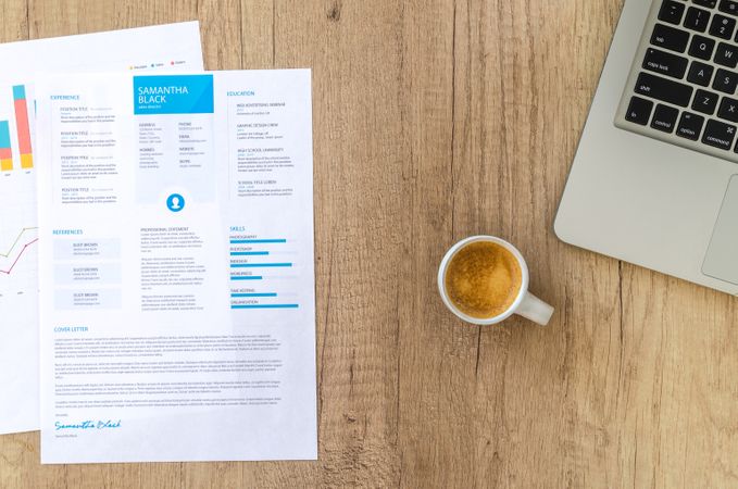 Papers And Mac-book On Wooden Table With Hot Coffee Photo
