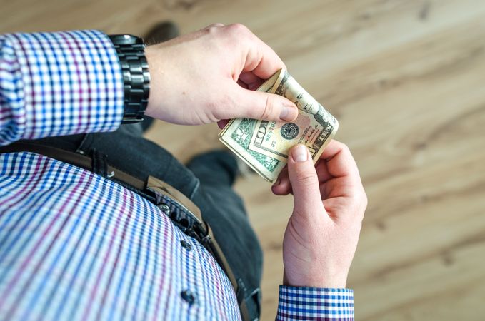 Person Holding 100 Us Dollar Banknote Photo
