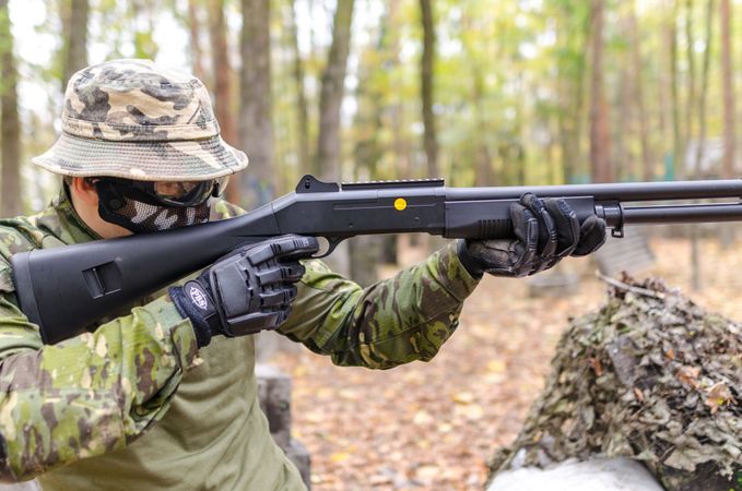 Person Holding Black Pump Shotgun Photo