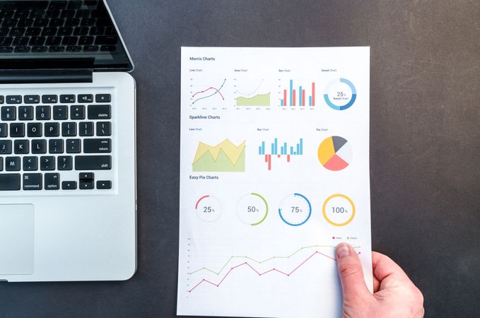 Person Holding Chart And Bar Graph Photo
