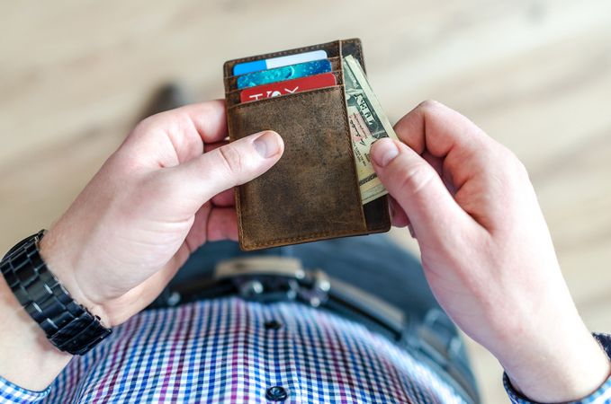 Person Taking Cash From Card Holder Photo
