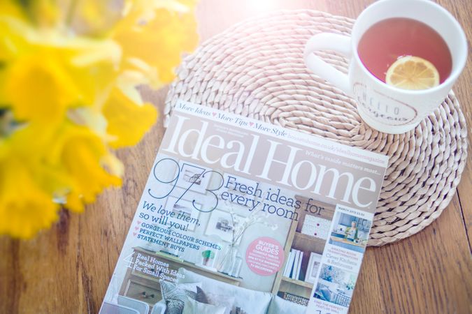 Photo Of Magazine Near Cup Of Tea On Wooden Table Photo