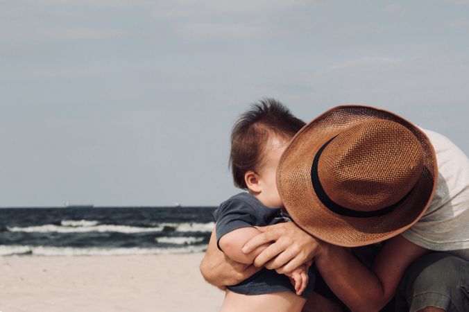 Photo Of Person Holding His Baby Photo