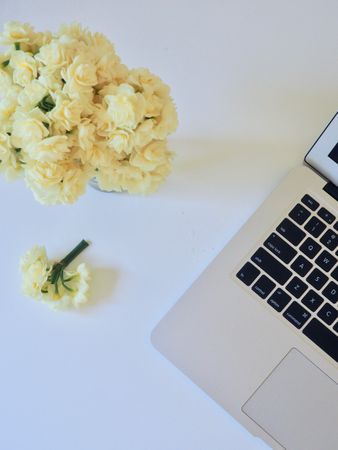 Photo Of Yellow Flower Bouquet And White And Black Laptop Computer Photo