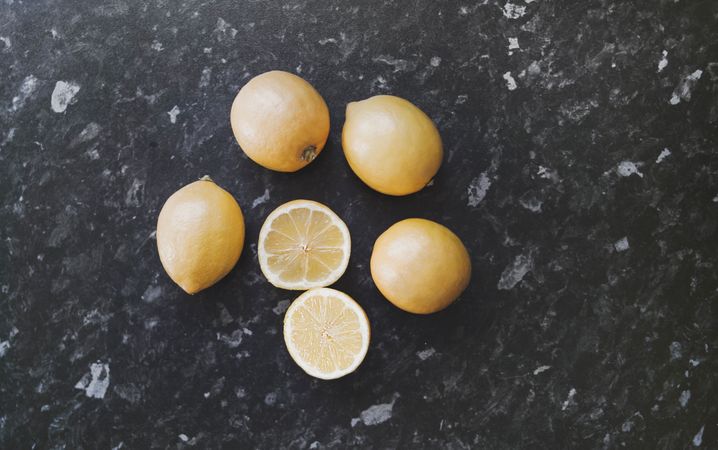 Photography Of Sliced Lemon On Black Marble Photo