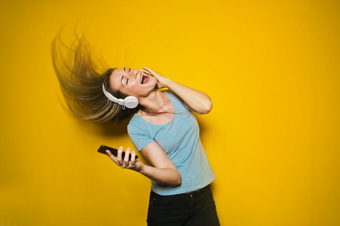 Photography Of Woman Listening To Music From Her Phone Photo