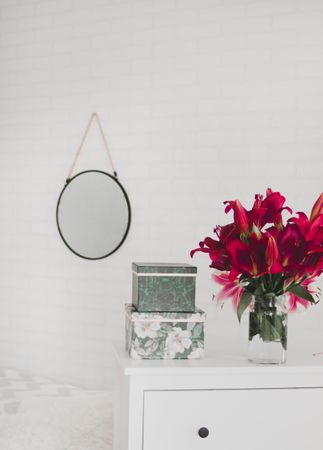Red Flower Centerpiece On White Wooden Drawer Dresser Photo