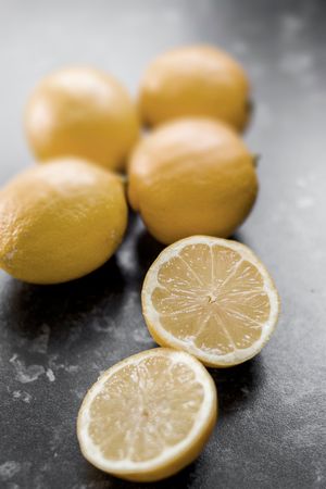 Shallow Focus Photography Of Sliced Lemon On Black Marble Photo