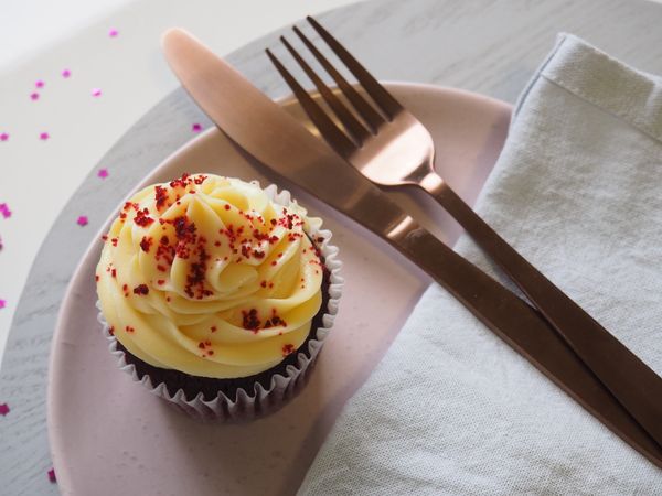 Silver Fork And Knife On Round Plate With Cupcake Photo