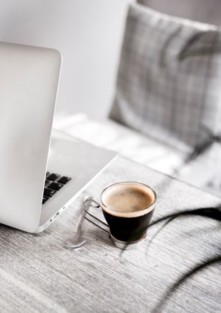 Silver Macbook And Cup Of Tea On Wooden Table Photo