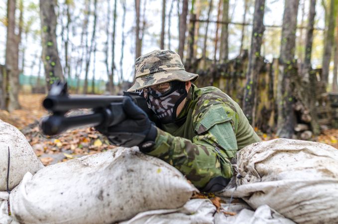 Soldier Holding A Rifle At Camp Photo