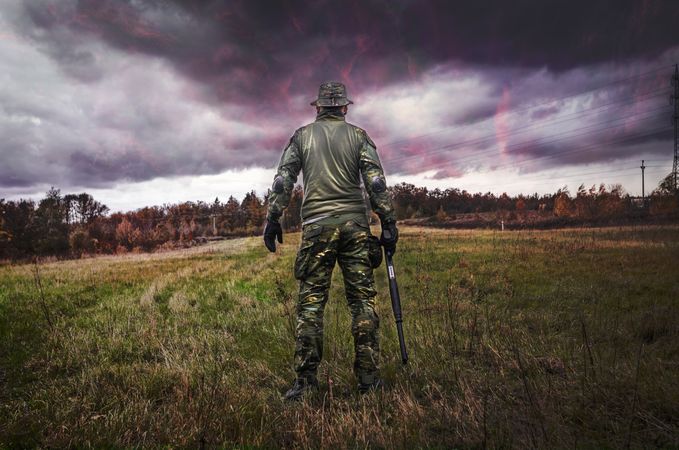 Soldiers Standing With Gun In Beautiful Cloudy Weather Photo