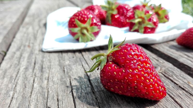 Strawberries On Top Of Brown Table Photo