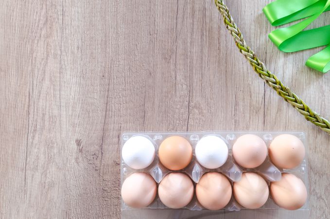 Ten Eggs On Egg Tray Beside Chain And Green Ribbon Photo
