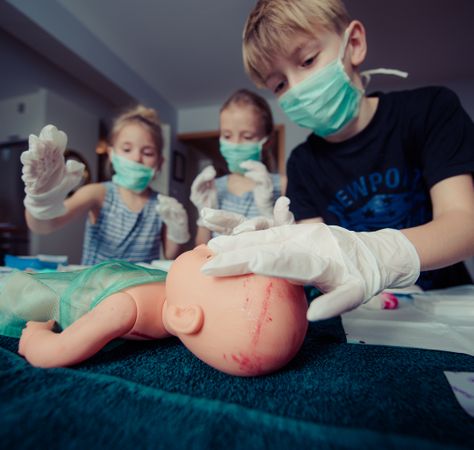 Three Children Playing Operation Toy Photo