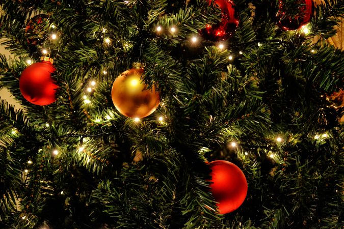 Three Christmas Ball And Some Light Decoration On Christmas Tree Photo