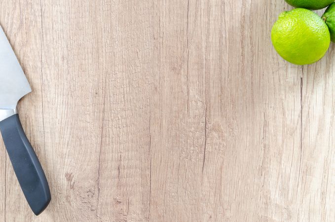 Three Limes With Knife On Wooden Table Photo