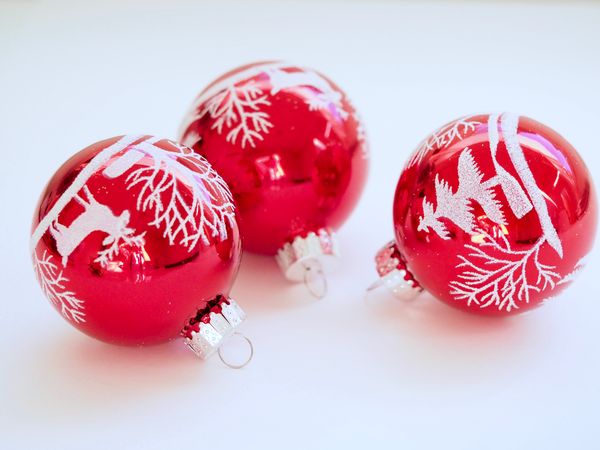 Three White-and-red Christmas Tree Printed Baubles Photo