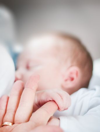 Tilt-shift Lens Photo Of Infant's Hand Holding Index Finger Of Adult Photo