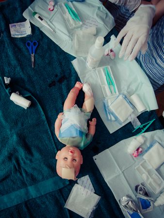 Top View Of Doll While Kids Playing Surgeon Photo