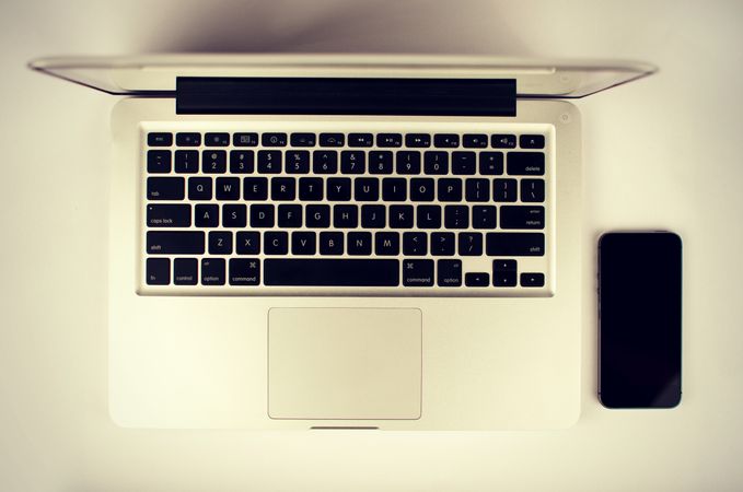 Top View Of Macbook With Iphone OnTable Photo