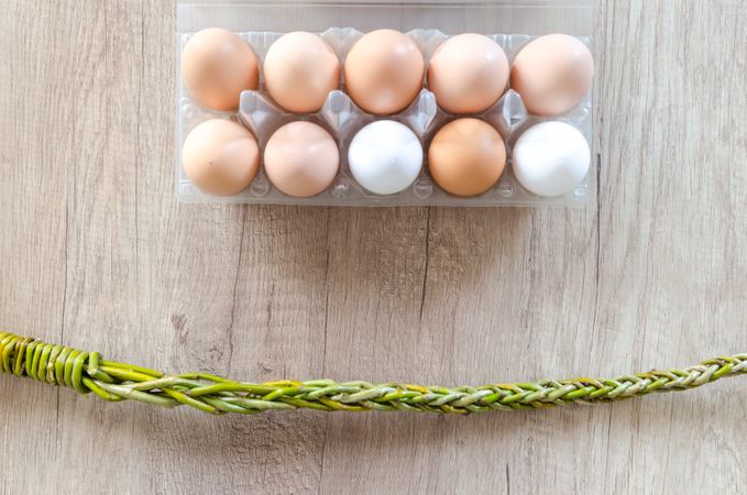 Top View Of Ten Eggs Tray And Chain On Wooden Table Photo
