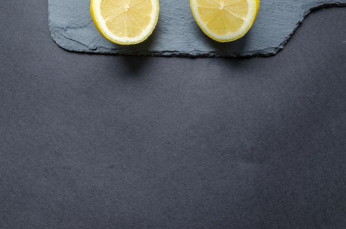 Two Sliced Lemons On Black Surface Photo