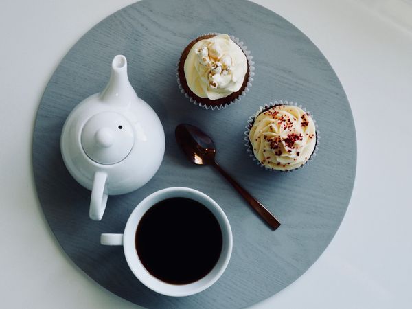 White Ceramic Cup And Teapot With Cupcakes Photo