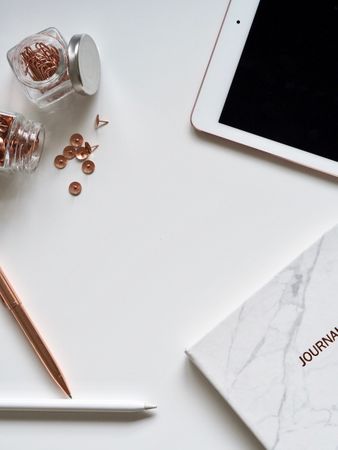 White Ipad On The Table Near Small Clear Glass Jars Photo